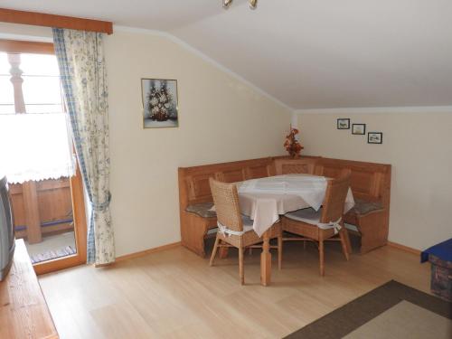 a dining room with a table and chairs at Appartement Alpenhof Wildschönau in Niederau