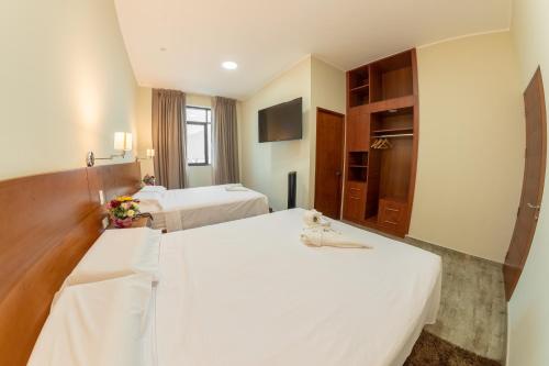 Un ou plusieurs lits dans un hébergement de l'établissement Caruzo Hotel and suites