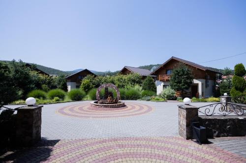 a courtyard with a fountain in the middle at Fantasia Hotel in Polyana