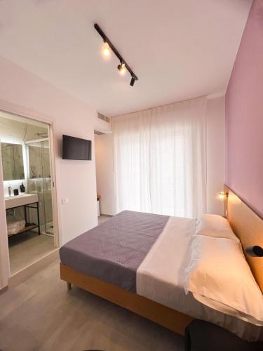 a bedroom with a large bed and a bathroom at Le Camere Del Centro in Matera
