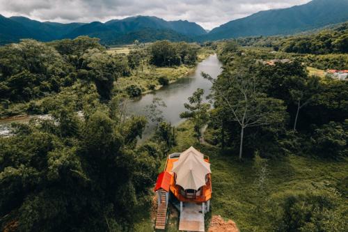 an aerial view of a tent next to a river at Sleeping Giant Rainforest Lodge in Belmopan