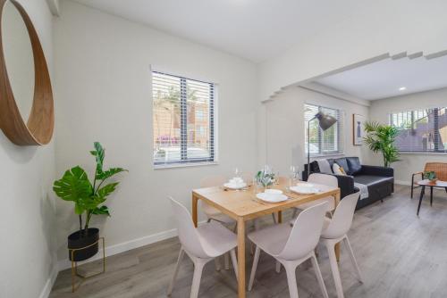 a dining room and living room with a table and chairs at Prime Location Apt on Calle Ocho in Little Havana in Miami