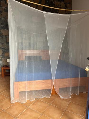 a stage with a white curtain over a bench at Casa Saúde in Seladinha