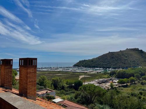 a view of a beach with a hill in the background at Porto Ercole Maison vista mare in Cala Galera