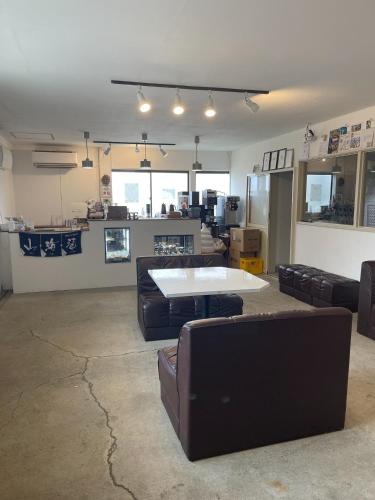 a living room with couches and a table in it at Tatu Stay&Bar - Vacation STAY 17780 in Shimanokoshi