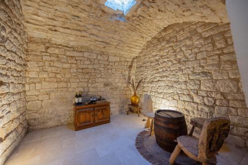a room with a barrel and a chair and a table at Unique Villa Pietra with heated private pool in Šestanovac