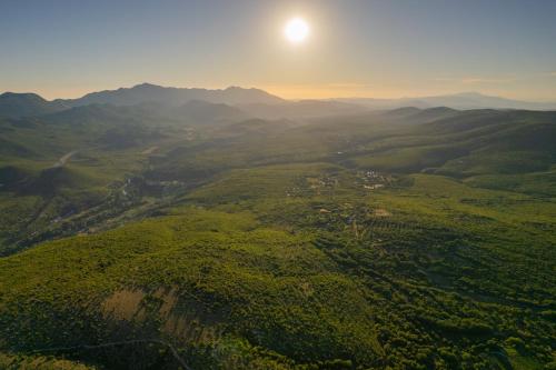 an aerial view of a valley with the sun in the sky at Unique Villa Pietra with heated private pool in Šestanovac