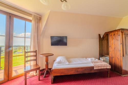 a bedroom with a bed and a large window at Pensjonat Sekuła*** in Bukowina Tatrzańska
