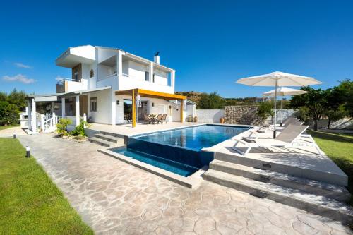 a villa with a swimming pool and a house at Villa Costazia in Kalithies
