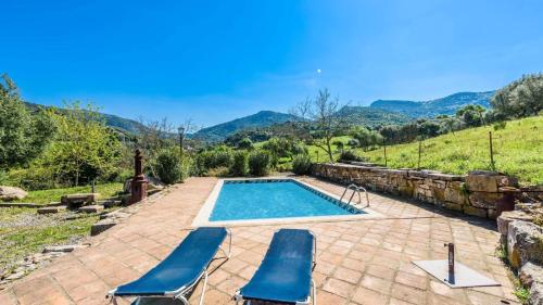 a swimming pool with two lounge chairs and a swimming pool at Casa del Tigre Gaucín by Ruralidays in Gaucín