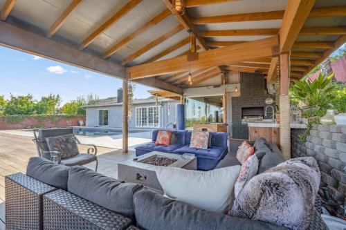 a patio with a couch and chairs on a patio at Middlebury Heights with Pool in Los Angeles