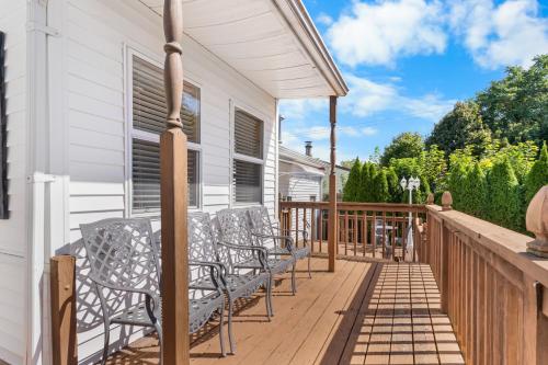 a deck with chairs and tables on a house at 3BR Gem, 10 min to Yale, walk to Tweed in New Haven