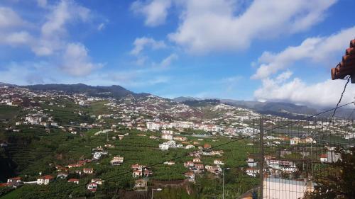 a view of a town on a hillside at Paraíso Pico da Torre in Câmara de Lobos