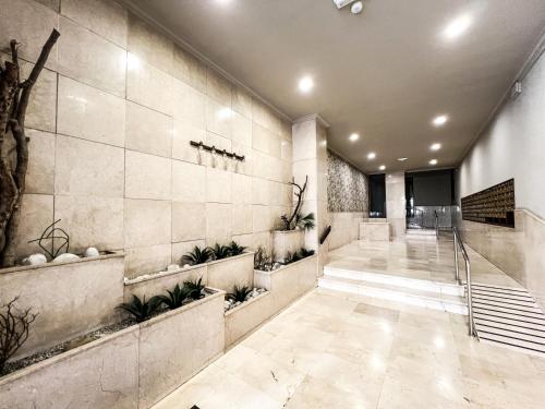 a lobby with a staircase and plants on the wall at The Olive Loft in Vigo