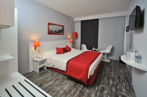 a hotel room with a bed with a red blanket at Hôtel The Originals City Le Berry - proche centre-ville - Gare in Bourges