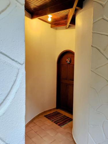 a hallway with a wooden door in a house at Tico Tiki Vacation Villa, 3 Bedroom in Sámara