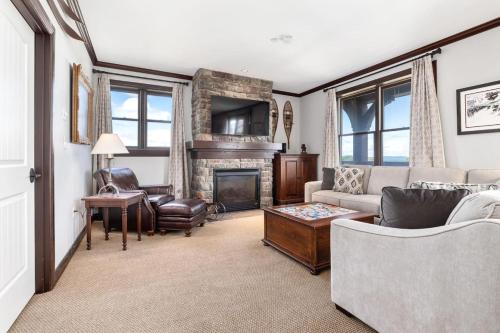 a living room with a couch and a fireplace at Hearthstone Escape in Stratton Mountain