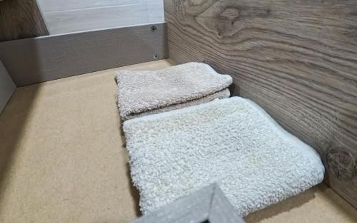 two white rugs sitting on the floor next to a couch at La Brisa Atlántica in Morro del Jable
