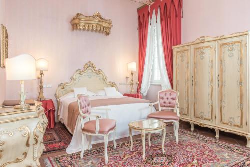 Un pat sau paturi într-o cameră la Duchessa Isabella Collection by Uappala Hotels