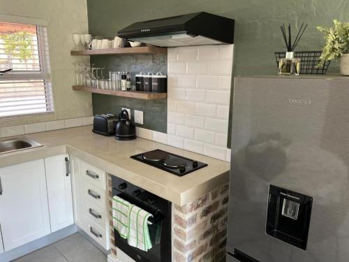 a kitchen with a stove and a counter top at 1402@Pont de Val in Parys