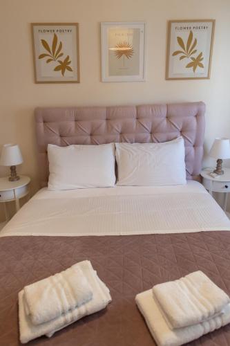 a bed with two towels sitting on top of it at Santa Marina 3 in Ioannina