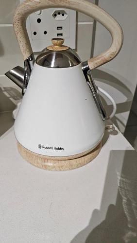 a white tea kettle sitting on top of a counter at The Blyde Crystal Lagoon 2 Bedroom Penthouse 1336 in Pretoria