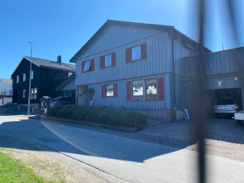 a house with a car parked in front of it at Cozy apartment near city center and nature in Kristiansund