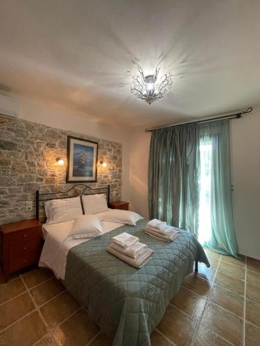 a bedroom with a bed with two towels on it at Skiathos Island Villas in Skiathos
