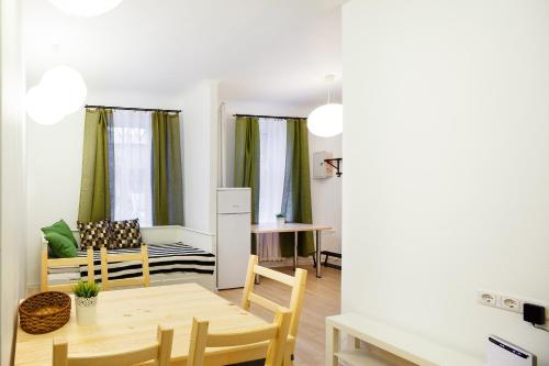 a kitchen and living room with a table and chairs at Lote Apartment in Rīga