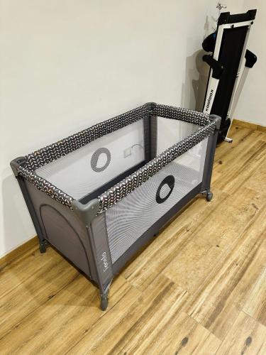 a metal bed frame on a wooden floor at Cats & Breakfast in Vogogna