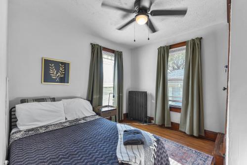 a bedroom with a bed and a ceiling fan at Luxury Midtown Home with Historic Charm in Omaha