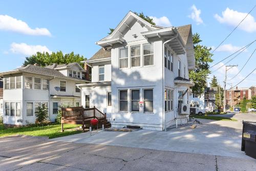 a white house with a bench in front of it at Luxury Midtown Home with Historic Charm in Omaha