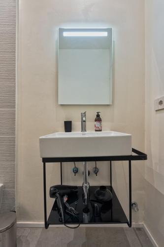 a bathroom with a sink and a mirror at Bligny Zero by Apartments To Art in Turin