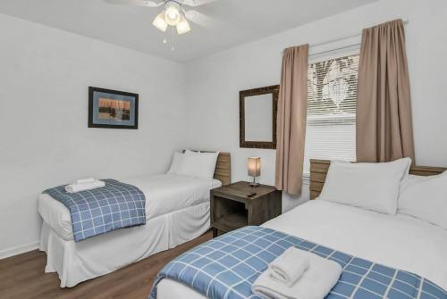 a hotel room with two beds and a window at Blue Park Nest - 3BR 2BA in West Columbia