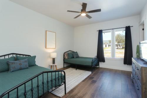 a bedroom with a bed and a ceiling fan at Heated Pool Movie Theater Hot Tub Games Sleeps 28 in Concan