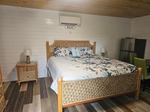 a bedroom with a large bed with blue and white pillows at Beautiful cozy cabin to relax in charleston sc in Charleston