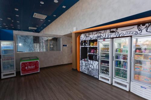 a store with two refrigerators and a trash can at ibis budget Parauapebas in Parauapebas