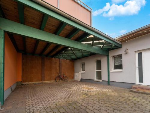 a bike parked under awning on the side of a building at Cozy Family Stay in Petersberg in Petersberg