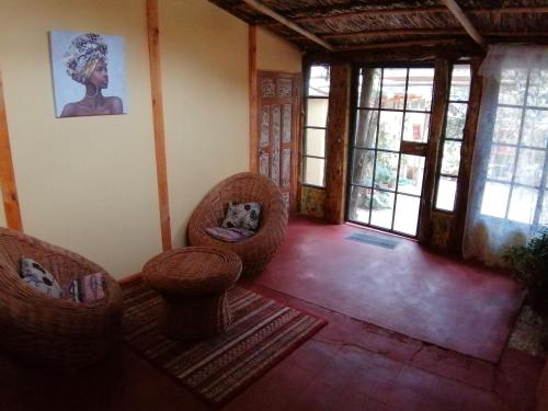 a living room with two chairs and a table at Elquihostel in Pisco Elqui