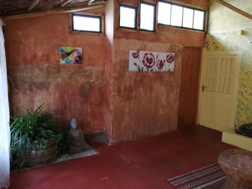 an empty room with paintings on the walls at Elquihostel in Pisco Elqui