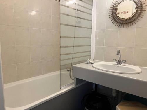 une salle de bain avec un lavabo, une baignoire et un miroir dans l'établissement Résidence Les Drus - Résidence LES DRUS N°202 MAE-4691, à La Plagne Tarentaise