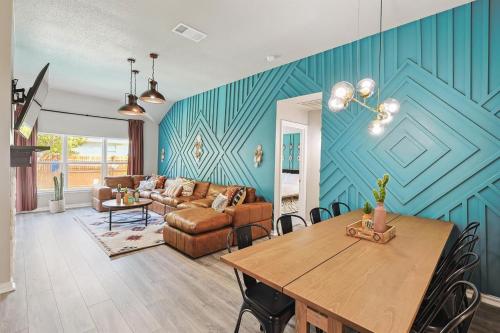 a living room with a table and a couch at 4BD 2BA Saginaw Sanctuary - Pool Firepit Laundry in Saginaw