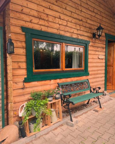 a bench sitting in front of a wooden house at Ferienhäuser an den Orgelpfeifen Scheibenberg in Scheibenberg