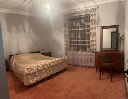 a bedroom with a bed and a dresser and a mirror at Jrvezh House in Yerevan