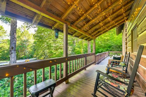 a deck with two benches on a house at Hot Tub and Fire Pit Cozy Cabin in Maggie Valley in Maggie Valley