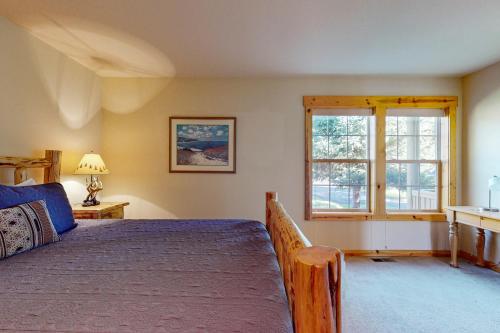 a bedroom with a bed and a window at Serenity at Eagle Crest in Redmond