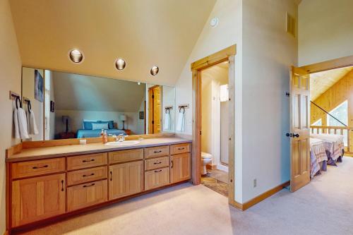 a bathroom with a sink and a large mirror at Serenity at Eagle Crest in Redmond