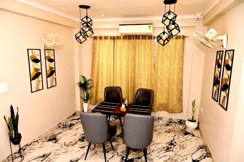 a dining room with a table and two chairs at Stay Inn Kaashvi (A unit of Admire India Tourism Pvt. Ltd.) in Varanasi