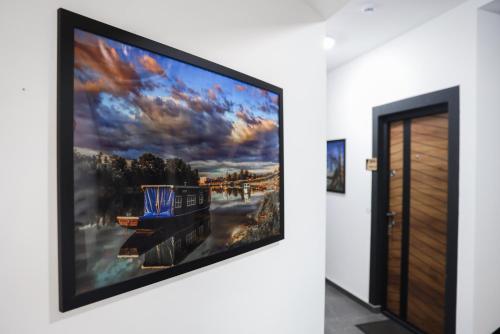 a large flat screen tv hanging on a wall at S Apart Rooms in Bosanska Gradiška