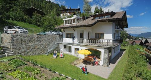 a group of people standing outside of a house at Ferienwohnungen Waldruhe in Santa Valburga St. Walburg